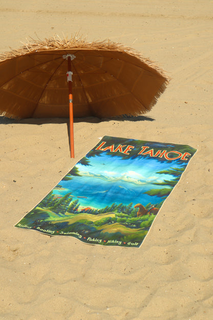 Lake Tahoe vintage travel poster beach towel laying in the sand under a tiki umbrella