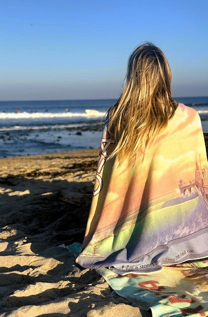 Huntington Beach vintage travel poster beach towel draped over a woman’s shoulder